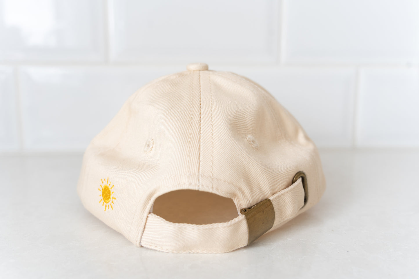 Kids' cap with fun 'But First, Fluffy' phrase, adding a playful touch to children’s casual wear.