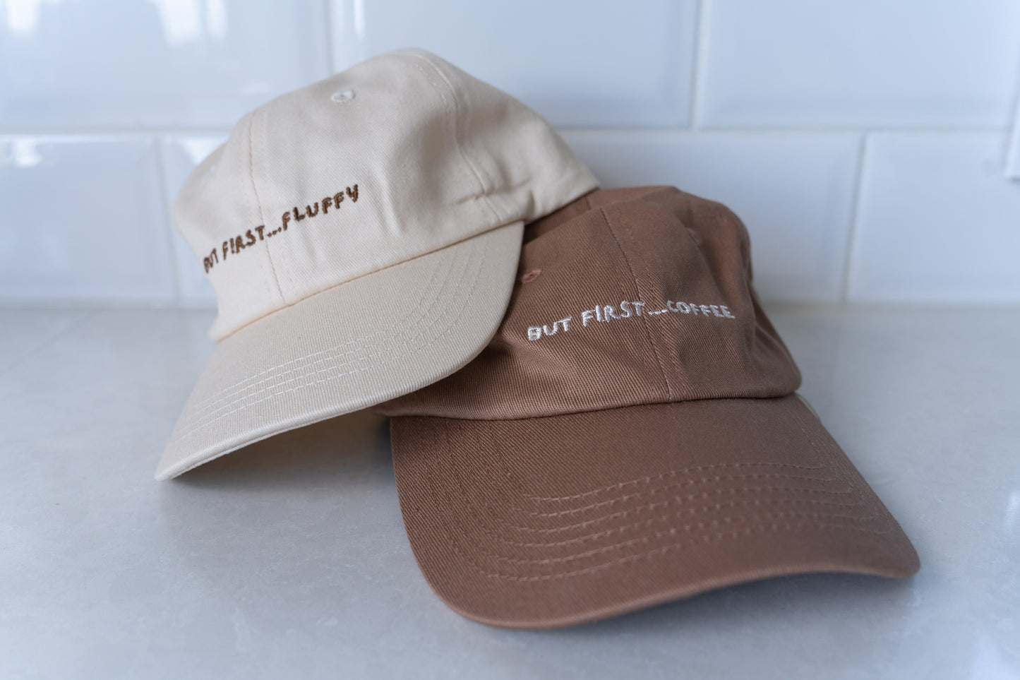Matching dad hats with 'But First, Coffee' and 'Fluffy' embroidery, perfect for couples or friends who love coffee and fluffies.