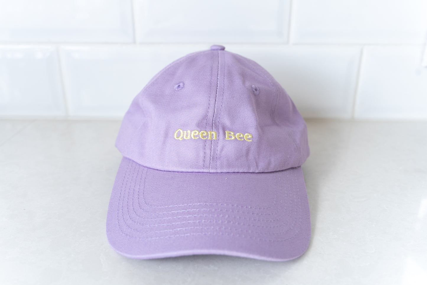 Stylish 'Queen Bee' hat for mums, perfect for adding a touch of fun and personality to casual outfits.