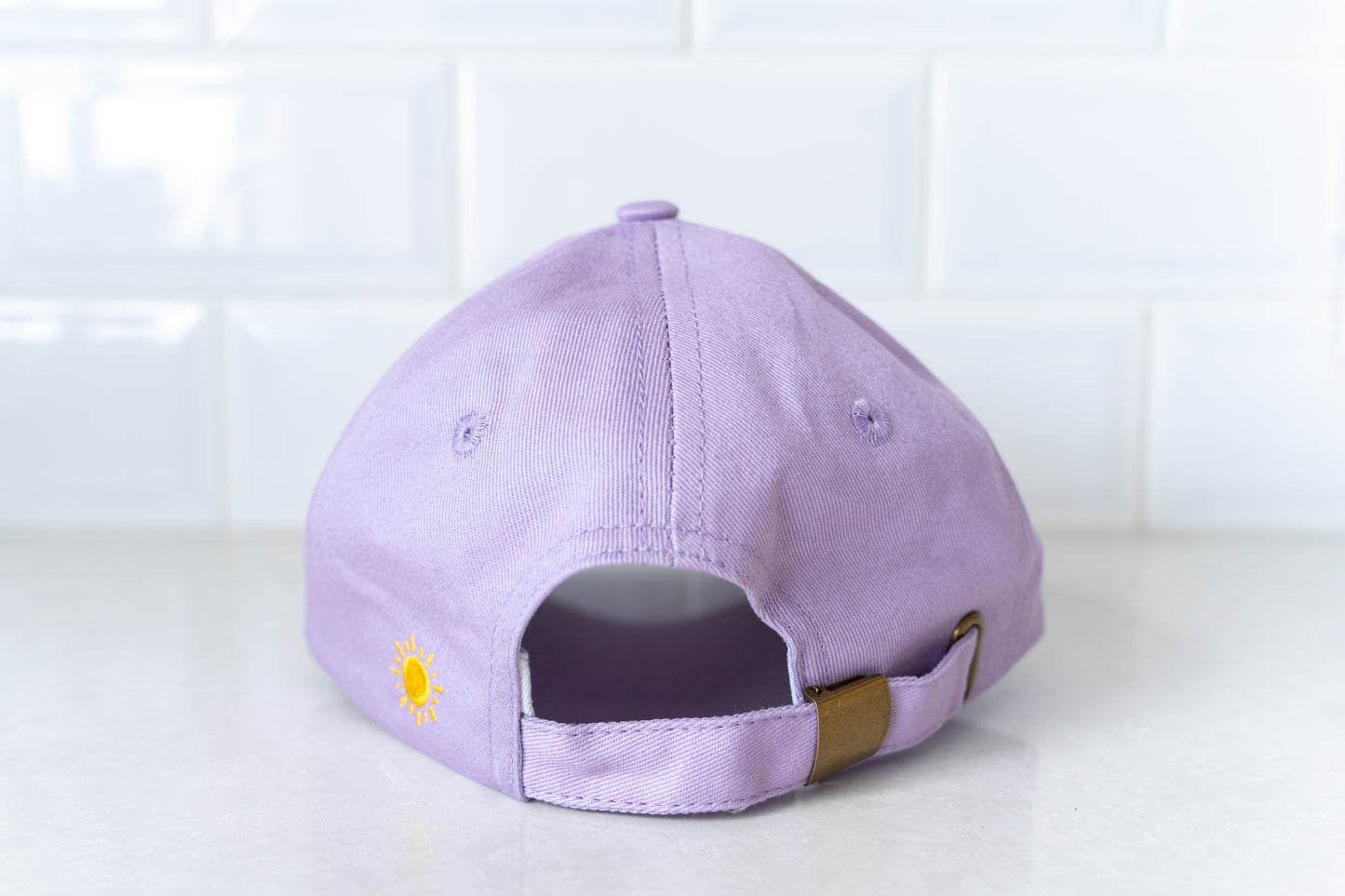 Purple 'Queen Bee' mum hat, a trendy accessory for mothers who want to showcase their playful side.