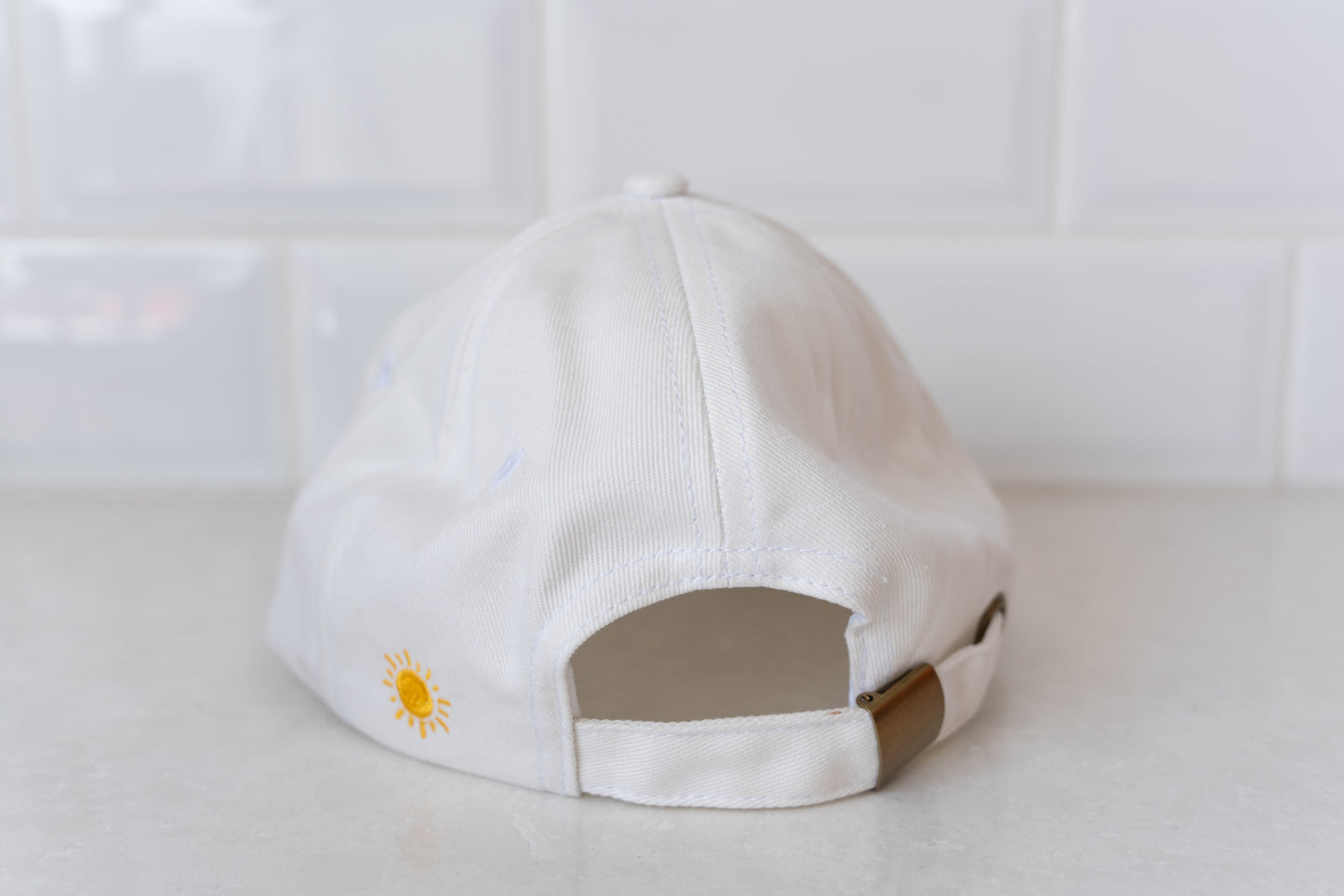 Adults' white hat with 'Staying Afloat' slogan, ideal for beach days, outdoor adventures, and sunny weather.