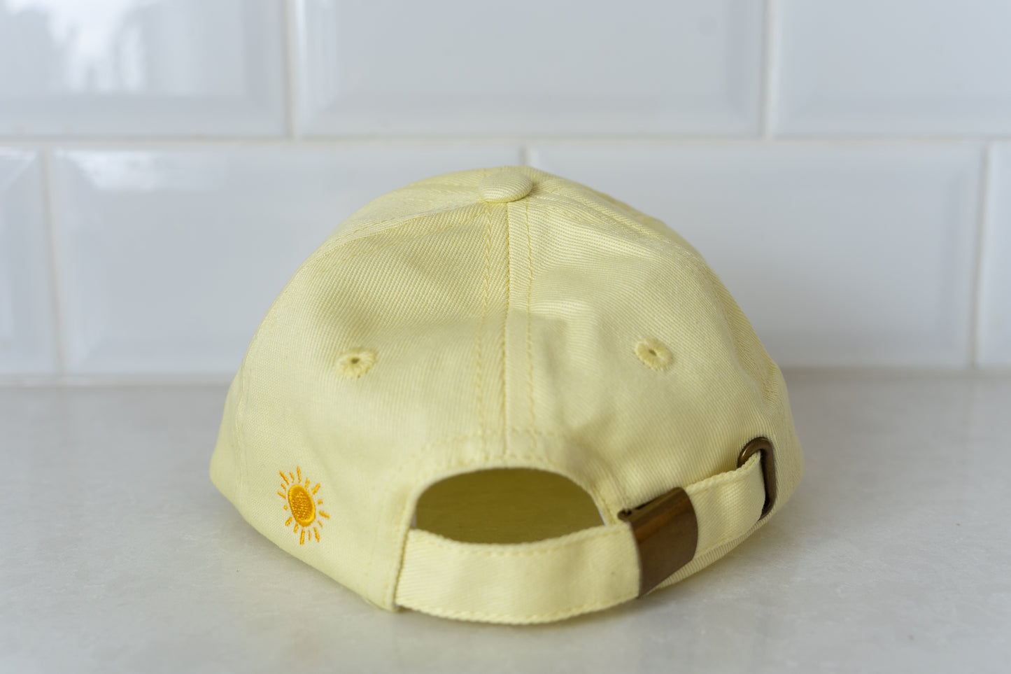 Yellow 'Busy Bee' hat for kids, combining sun safety with a playful design.