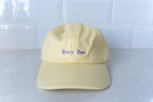 Yellow kids' hat with 'Busy Bee' embroidery, perfect for active children and outdoor play.