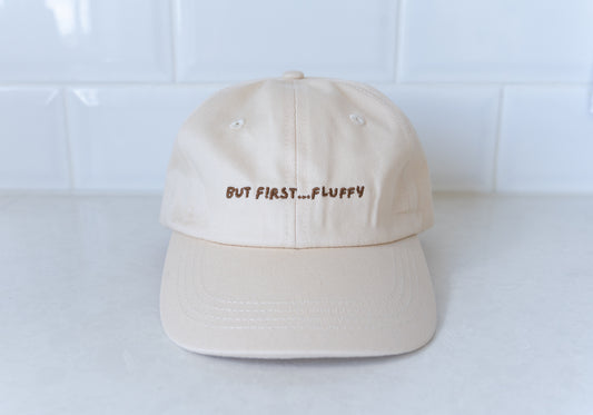 Kids' hat with 'But First, Fluffy' text, perfect for little ones who love fluffies.