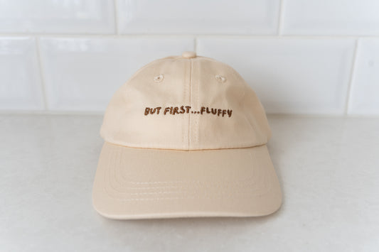 Kids' hat with 'But First, Fluffy' text, perfect for little ones who love fluffies.