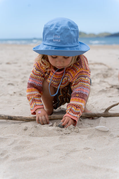 Close-up of 'Little Ripper' text on blue kids' bucket hat, perfect for adventurous little ones and outdoor activities.