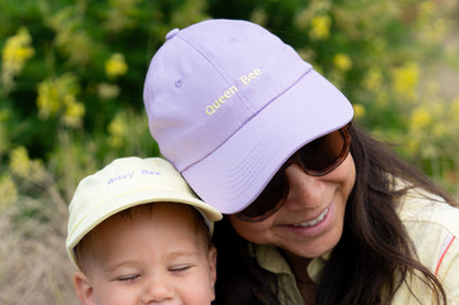 Mother and baby matching hats with 'Queen Bee' for mums and 'Busy Bee' for kids, a cute duo for family bonding and sun protection.