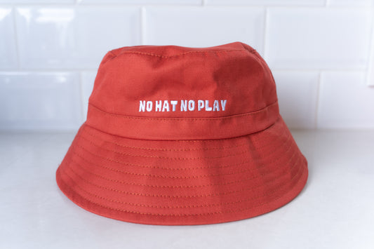 Bright red kids' bucket hat with 'No Hat No Play' embroidered text, designed for sun protection during outdoor play.
