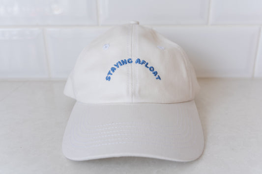 White 'Staying Afloat' hat for adults, perfect for stylish sun protection and casual wear.