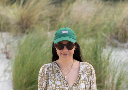 Dark green 'Thriving Surviving' parent hat, combining comfort and a positive, motivational message.